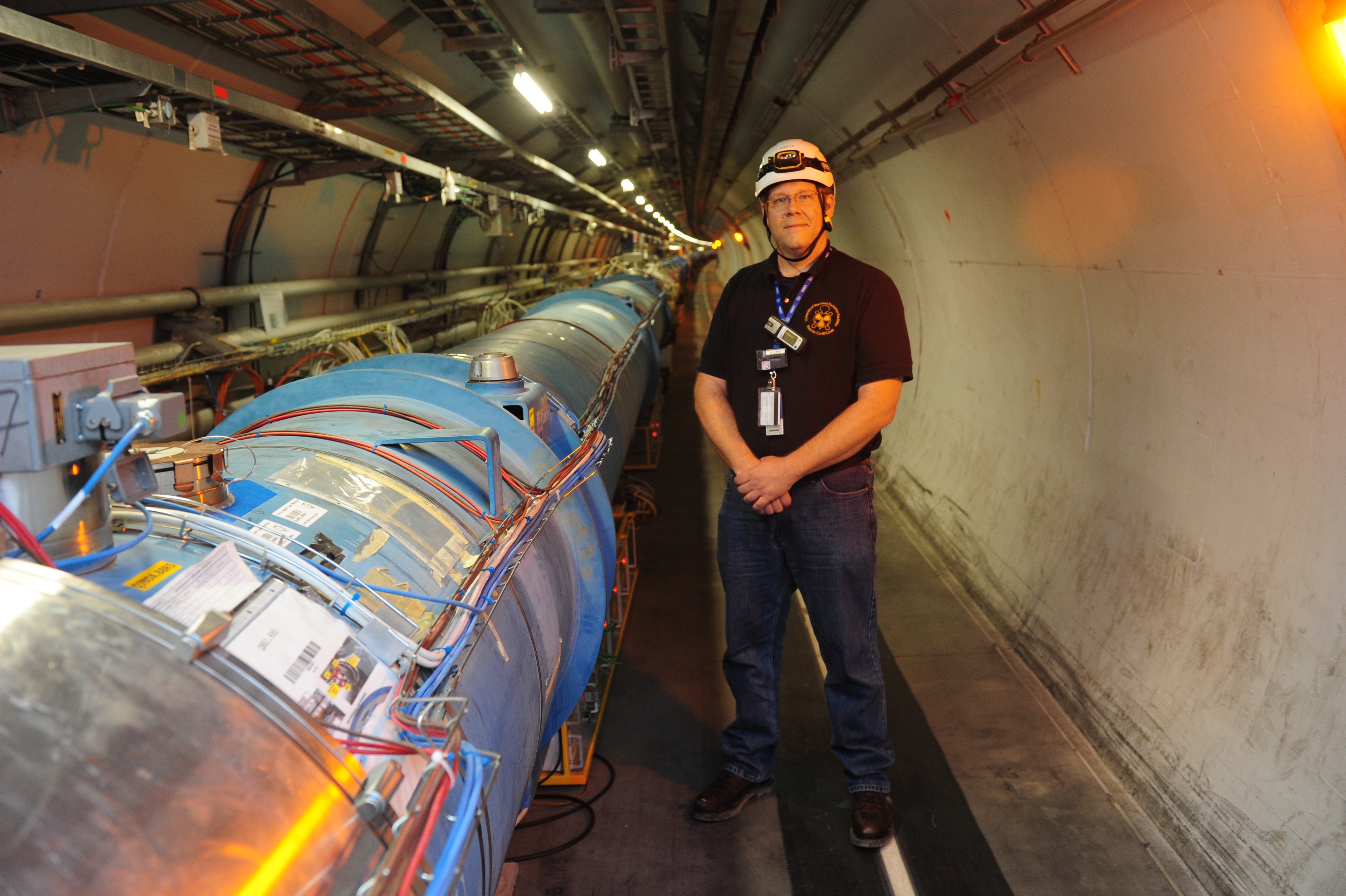 Tim standing next to the LHC at CERN Tim in LHC tunnel at CERN